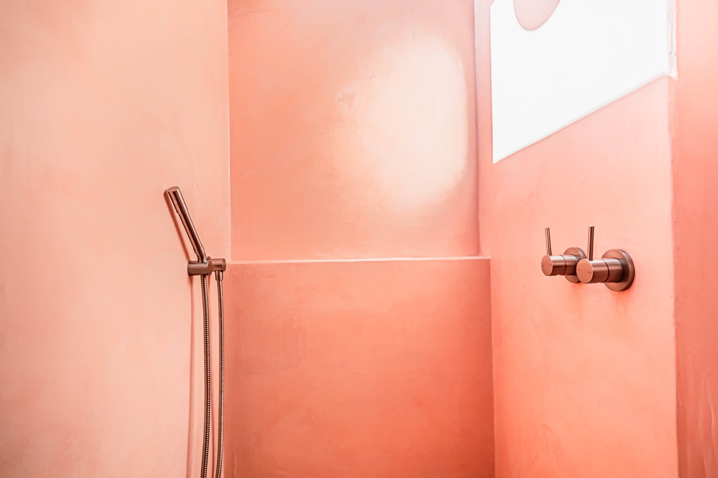 Seamless terracotta microcement shower recess with copper tapware — Didsbury Street, Bulimba.