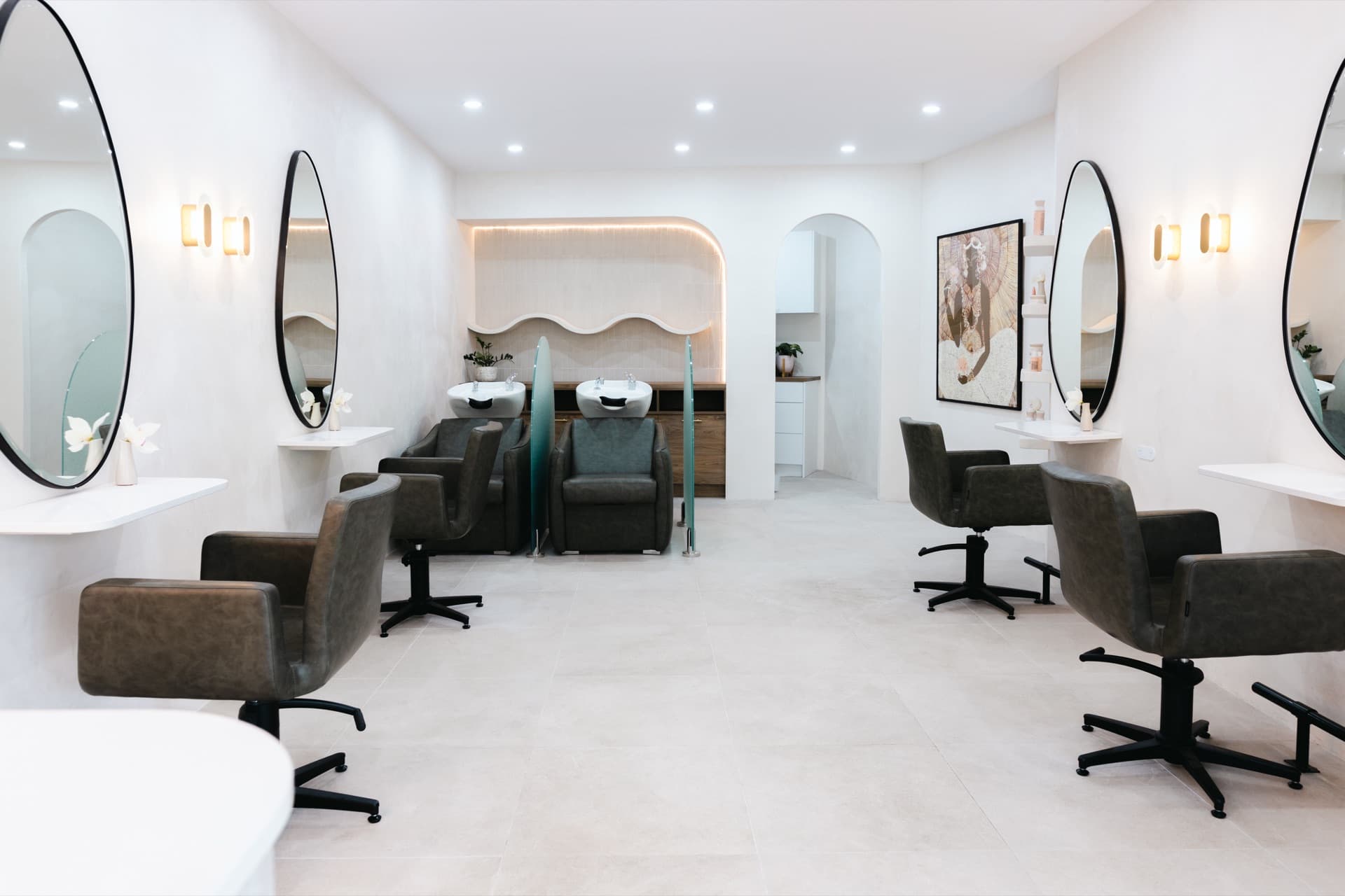 Limewashed salon interior — soft, broken-colour walls with arched detailing.